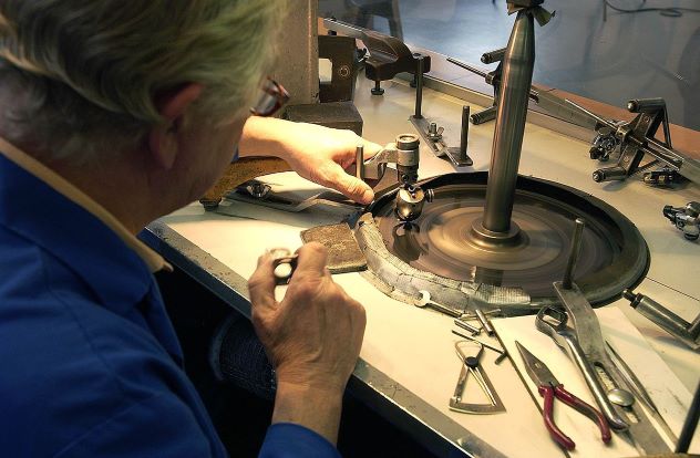 Craftsman cutting diamond in workshop