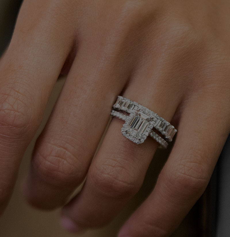Emerald-cut engagement ring with diamond encrusted wedding band