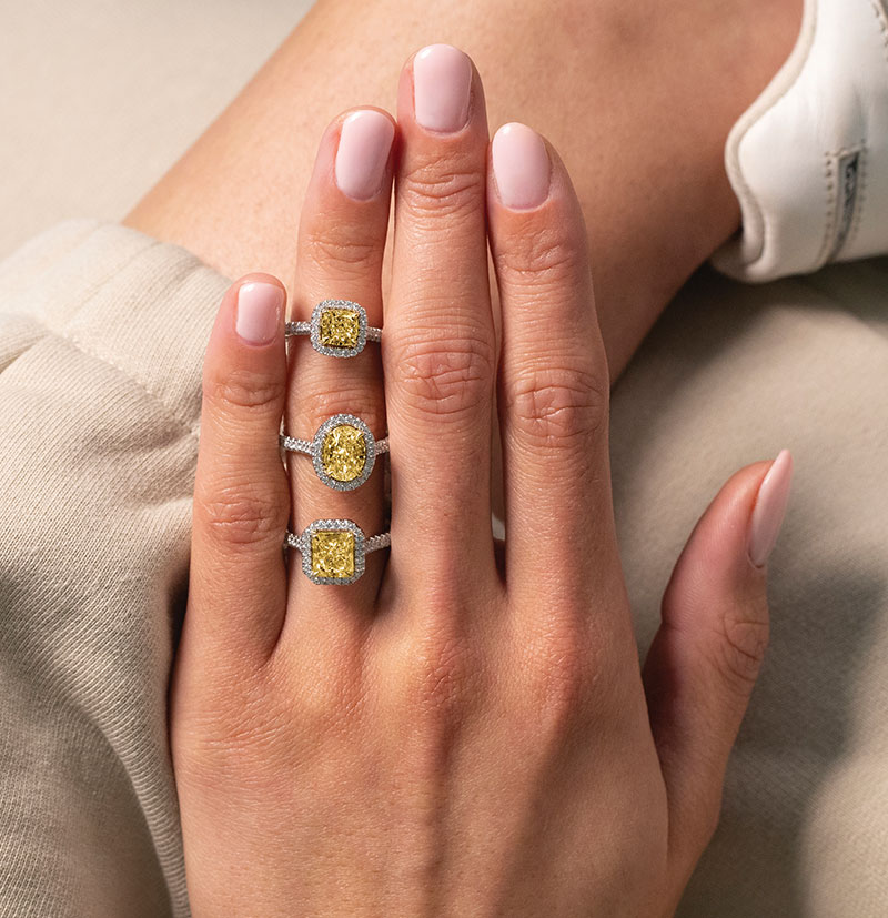 Trio of yellow diamond engagement rings