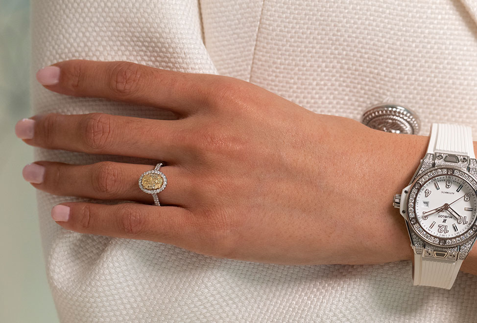 woman wearing yellow diamond engagement ring